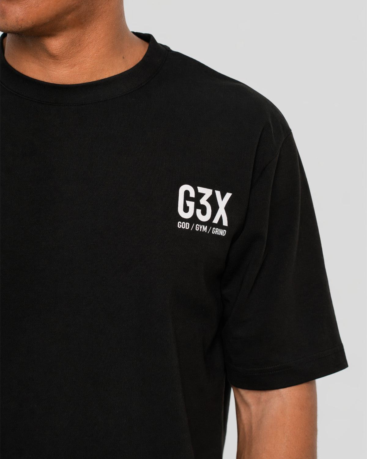 Black t-shirt with 'G3X' logo worn by a person on a gray background