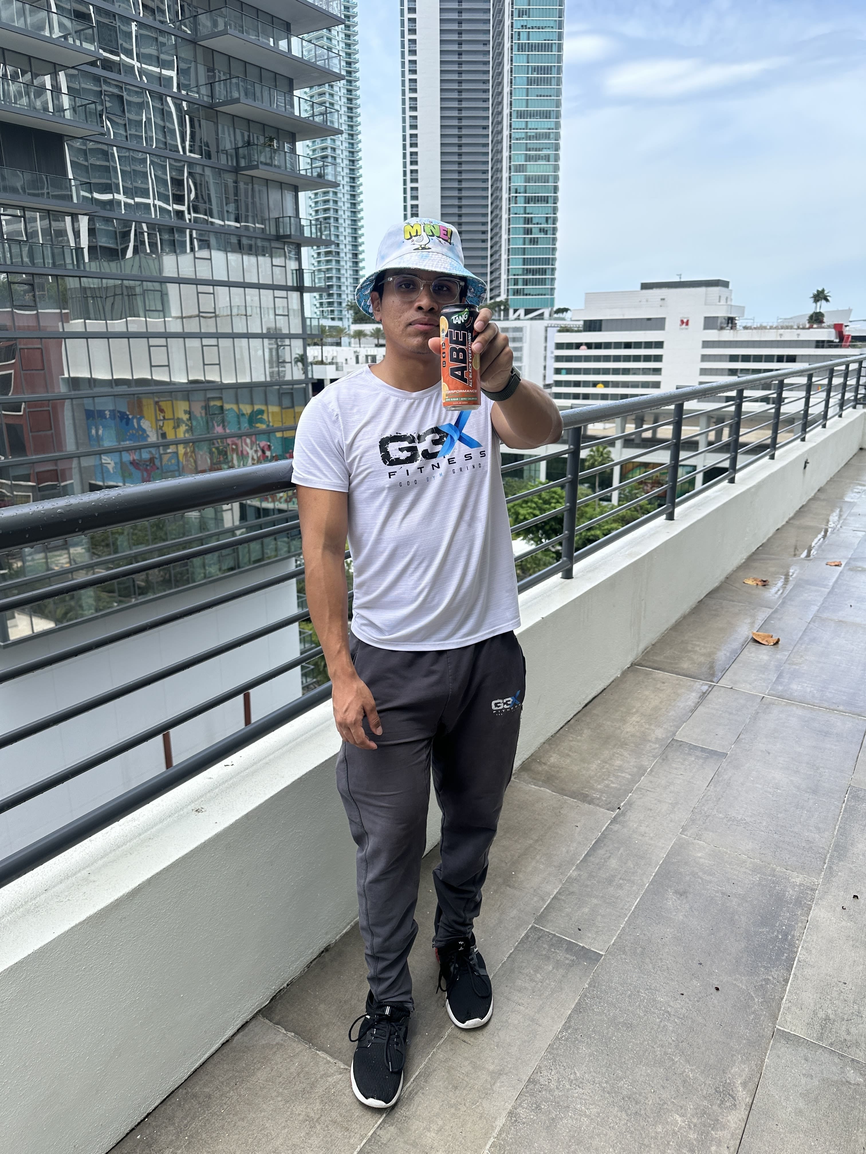 Adriel Founder G3X Fitness holding ABE Pre workout can