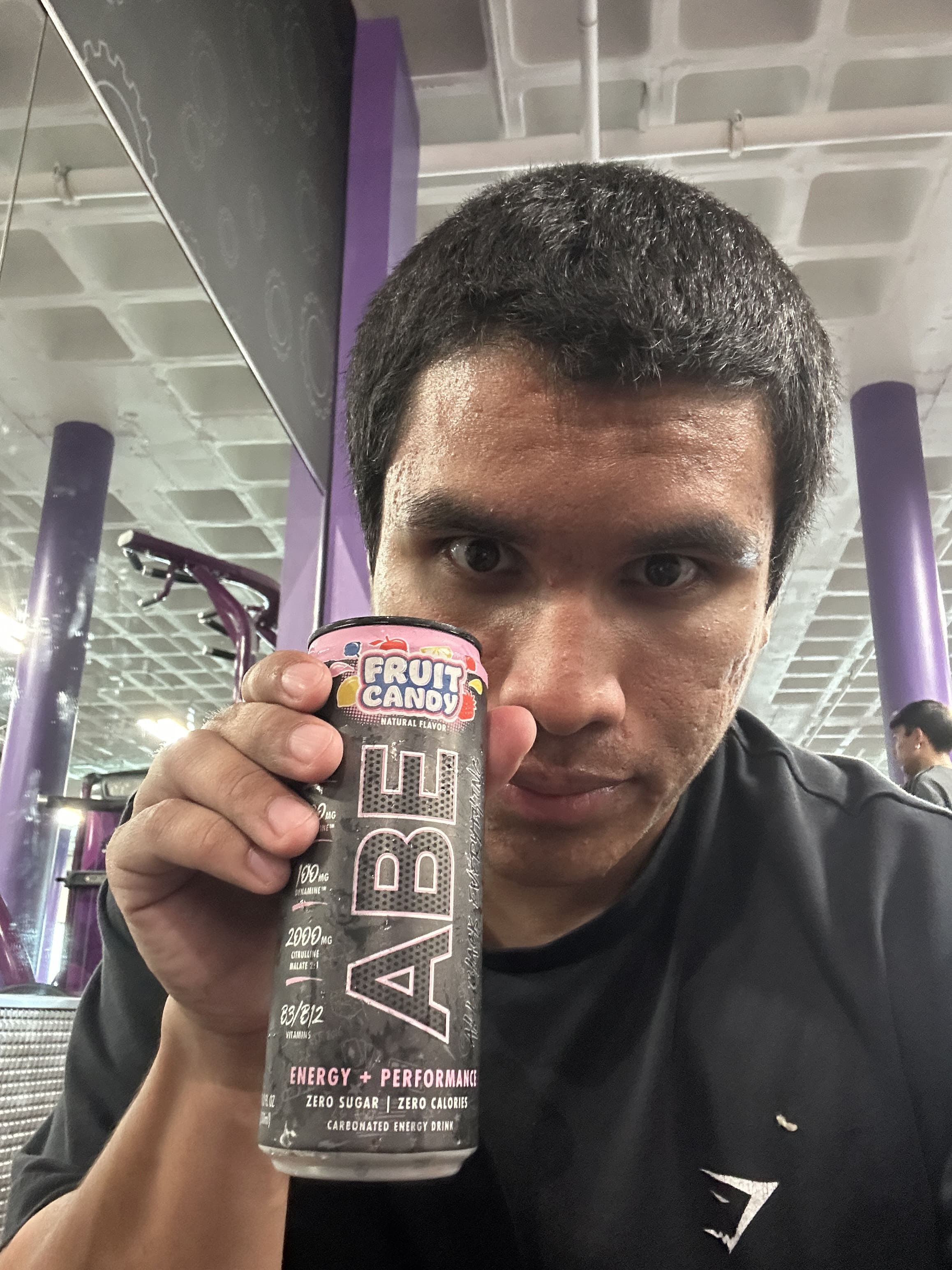 Adriel Founder G3X Fitness holding ABE Pre workout can