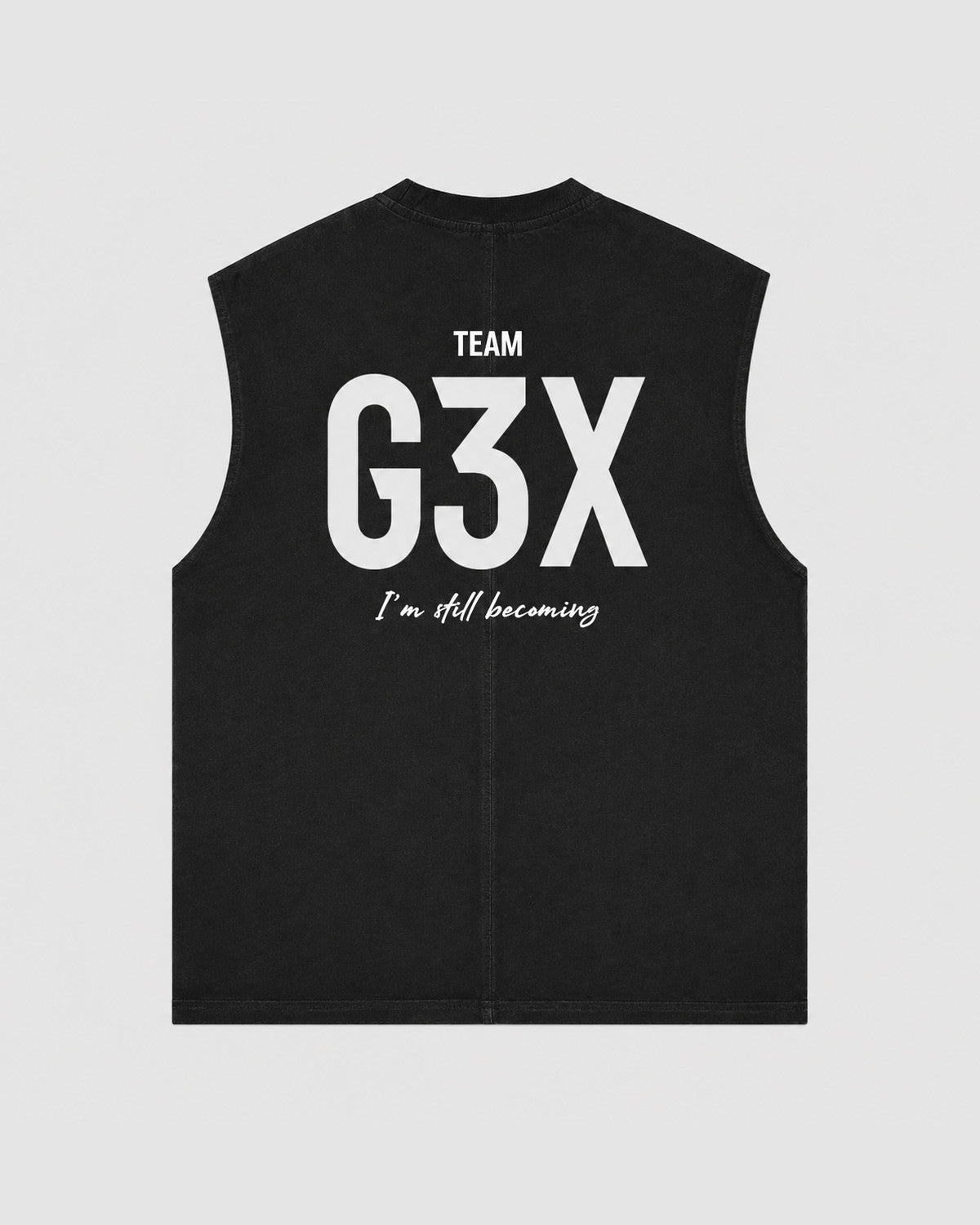Black sleeveless vest with 'Team G3X I'm still becoming' text on a light gray background